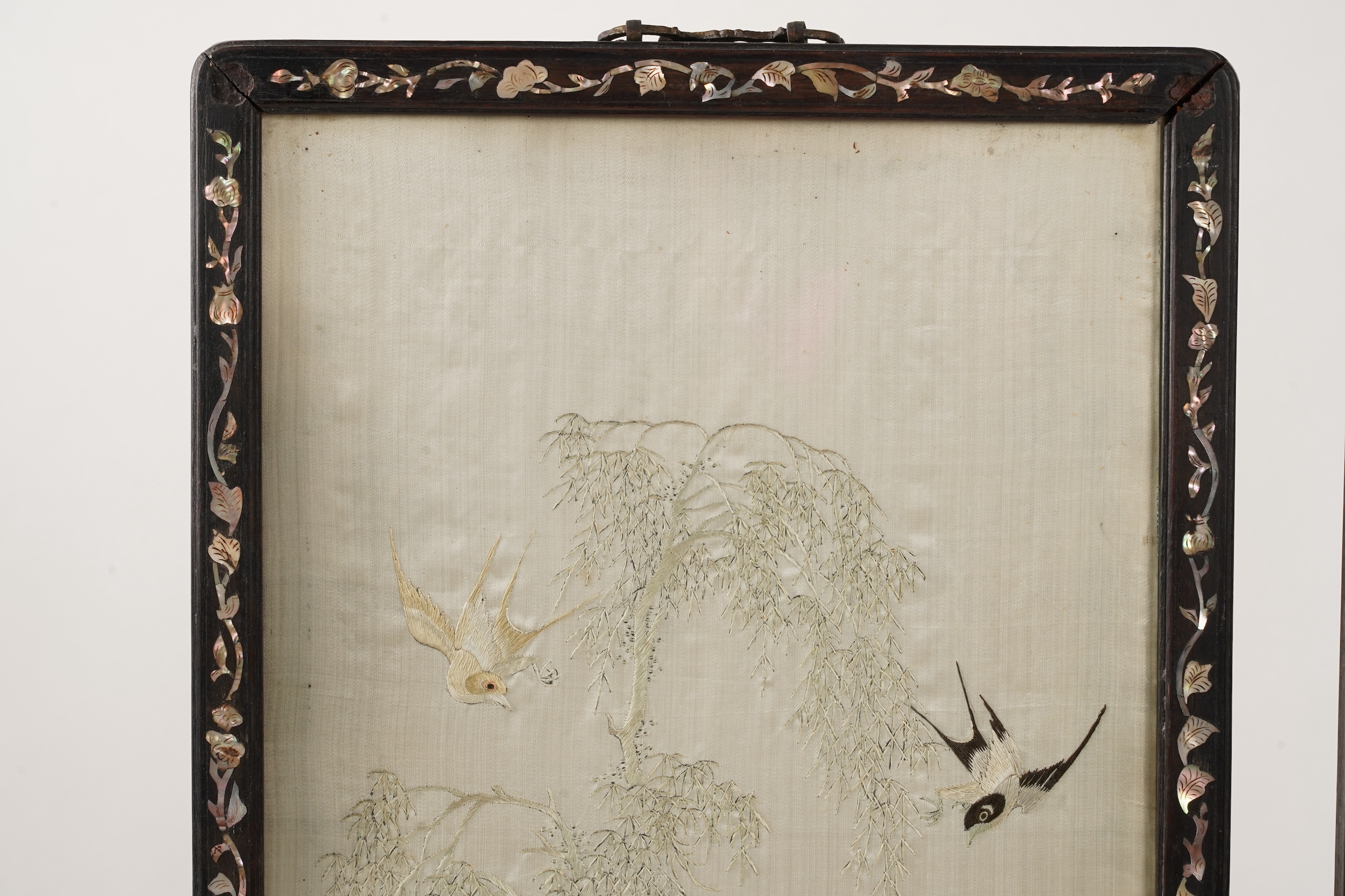 A pair of Chinese embroidered silk ‘bird’ panels, in mother-of-pearl inlaid hongmu frames, late 19th/early 20th century